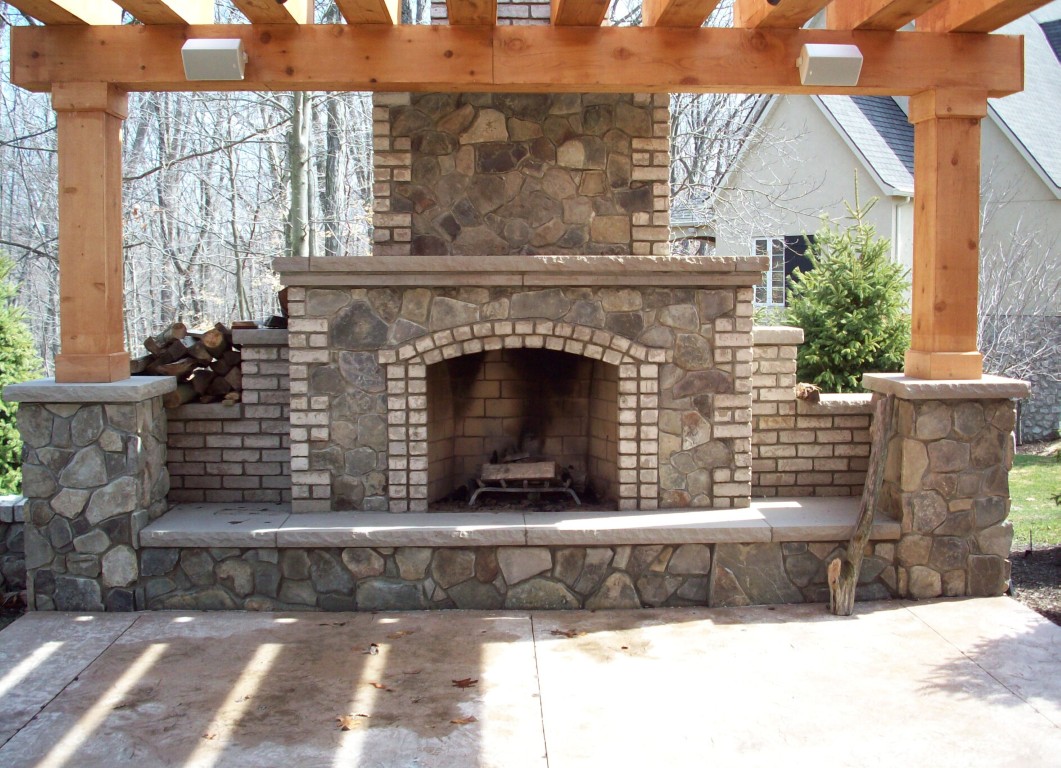 Custom outdoor fireplace and kitchen construction in Metairie, LA